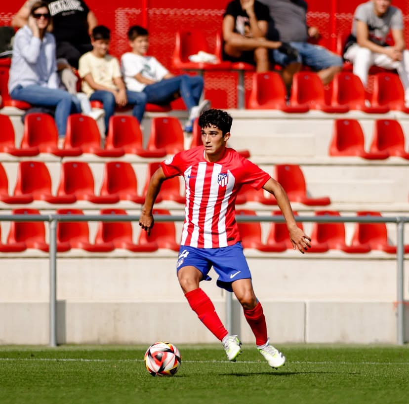 Young footballer carrying the ball during a match